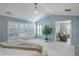 Airy main bedroom with plantation shutters, vaulted ceiling, and comfortable sitting area at 14032 Park Cove Dr, Broomfield, CO 80023