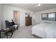 Bright bedroom with a dresser, armchair and en-suite bathroom at 13496 E 103Rd Ave, Commerce City, CO 80022