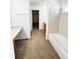 A bathroom with a shower, tub, and dual sink vanity at 20401 E Chenango Pl, Aurora, CO 80015