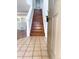 Inviting entryway featuring tile flooring transitioning to hardwood stairs and an open view of the living spaces at 20401 E Chenango Pl, Aurora, CO 80015
