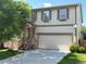 Charming two-story home with neutral siding, attached two-car garage, and well-manicured front lawn at 20401 E Chenango Pl, Aurora, CO 80015