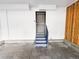 Inside a garage featuring access door, painted walls and floor and wood siding at 20401 E Chenango Pl, Aurora, CO 80015