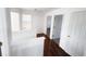 A hallway with wood floors featuring white walls and door frames at 20401 E Chenango Pl, Aurora, CO 80015