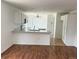 Open kitchen and breakfast nook with white cabinets and countertops at 20401 E Chenango Pl, Aurora, CO 80015