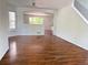 Spacious living room with hardwood floors, white walls, and an open layout for entertaining and relaxation at 20401 E Chenango Pl, Aurora, CO 80015