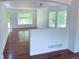 Spacious living area with hardwood floors, a half wall, and natural light, enhancing the home's open feel at 20401 E Chenango Pl, Aurora, CO 80015