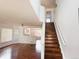 Bright living room with hardwood floors, white walls, and an open staircase, perfect for modern living at 20401 E Chenango Pl, Aurora, CO 80015