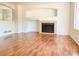 Cozy living room featuring hardwood floors, a fireplace, and ample natural light, perfect for Gathering gatherings at 20401 E Chenango Pl, Aurora, CO 80015