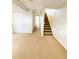 Neutral colored carpeted living room leading to a staircase and hallway at 20401 E Chenango Pl, Aurora, CO 80015