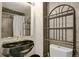 Bathroom featuring a dark-colored sink, modern fixtures, and decorative shelving at 9135 Bellaire St, Thornton, CO 80229