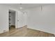 This bedroom boasts wood-look flooring, white walls, and a walk-in closet with ample storage space at 9135 Bellaire St, Thornton, CO 80229