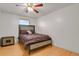 Bedroom showcasing bed with decorative headboard, stylish nightstand, and hardwood floors at 9135 Bellaire St, Thornton, CO 80229