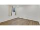 Bedroom showcasing neutral-toned plank flooring, white walls and a bright window at 9135 Bellaire St, Thornton, CO 80229