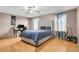 Bedroom with wood floors, a ceiling fan, a bed, and natural lighting at 9135 Bellaire St, Thornton, CO 80229
