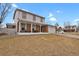 Inviting two-story home boasting a covered front porch with seating and a well-maintained lawn at 9135 Bellaire St, Thornton, CO 80229