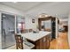A contemporary kitchen features a center island with seating, wood floors and stainless steel refrigerator at 9135 Bellaire St, Thornton, CO 80229