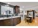 A modern kitchen showcases dark cabinets, an island with seating, and backyard access at 9135 Bellaire St, Thornton, CO 80229