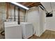 The laundry area features a washer, dryer, and utility connections in an unfinished basement area at 9135 Bellaire St, Thornton, CO 80229