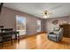 Relaxing living room boasting hardwood floors, natural light, and comfortable leather seating at 9135 Bellaire St, Thornton, CO 80229