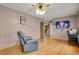 Comfortable living room highlighting hardwood floors, leather seating, and modern television at 9135 Bellaire St, Thornton, CO 80229