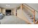 Cozy living room highlighting tile floors, staircase, comfortable leather seating, and a television at 9135 Bellaire St, Thornton, CO 80229