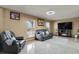 Comfortable living room featuring tile floors, natural light, leather seating, and a fireplace at 9135 Bellaire St, Thornton, CO 80229