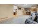 Open living room showcasing tile floors, staircase, and comfortable seating arrangement at 9135 Bellaire St, Thornton, CO 80229