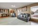 Spacious living room featuring tile flooring, natural light, comfortable leather seating, and tasteful decor at 9135 Bellaire St, Thornton, CO 80229
