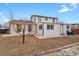 View of the rear of the home featuring neutral siding, replacement windows, and a brick paver patio area at 9135 Bellaire St, Thornton, CO 80229
