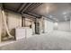 Basement featuring laundry machines, utilities, and carpeted floor at 624 S Depew St # C, Lakewood, CO 80226