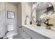 Bathroom featuring a toilet, sleek mirror, and an elegant vanity at 624 S Depew St # C, Lakewood, CO 80226