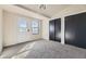 Bedroom showing a door to the backyard and including closet with sliding doors at 624 S Depew St # C, Lakewood, CO 80226