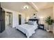 Comfortable bedroom features plush carpet, stylish lighting, and easy access to adjacent spaces at 624 S Depew St # C, Lakewood, CO 80226