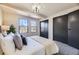 Bedroom showcasing windows, a closet, and a well-styled bed with decorative pillows at 624 S Depew St # C, Lakewood, CO 80226