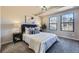 Comfortable bedroom features two windows, plush carpet, and elegant decor at 624 S Depew St # C, Lakewood, CO 80226