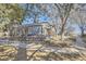 Side view of a well-maintained home featuring classic architecture and mature trees enhancing its curb appeal at 624 S Depew St # C, Lakewood, CO 80226