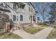 Inviting home exterior showcases a charming porch, complemented by a landscaped yard and brick accents at 624 S Depew St # C, Lakewood, CO 80226