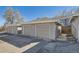 Driveway view of garages with light neutral colored doors at 624 S Depew St # C, Lakewood, CO 80226