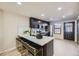 Modern kitchen features sleek black cabinets, a stylish island with seating, and stainless steel appliances at 624 S Depew St # C, Lakewood, CO 80226
