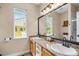 Bright bathroom features double sinks, granite countertops, and a large mirror for a luxurious feel at 6813 W Yale Ave, Lakewood, CO 80227