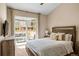 Bright bedroom with a sliding glass door to a private patio and a comfortable, inviting bed at 6813 W Yale Ave, Lakewood, CO 80227