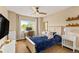 Comfortable bedroom featuring a desk, a large window, and a modern ceiling fan for a cozy atmosphere at 6813 W Yale Ave, Lakewood, CO 80227