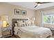 Inviting bedroom showcasing a comfortable bed with neutral bedding and an abundance of natural light from a window at 6813 W Yale Ave, Lakewood, CO 80227