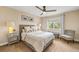 A serene bedroom with a large window, neutral color scheme, and soft lighting for a peaceful retreat at 6813 W Yale Ave, Lakewood, CO 80227