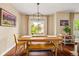Bright dining room featuring wooden table and bench with natural light at 6813 W Yale Ave, Lakewood, CO 80227