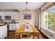 Cozy dining area with a wooden table set, modern lighting, and a view of the neighborhood at 6813 W Yale Ave, Lakewood, CO 80227
