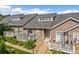 Charming townhome exterior with a private deck, manicured landscaping, and a welcoming entrance at 6813 W Yale Ave, Lakewood, CO 80227