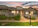 Inviting home exterior featuring a front porch with colorful sunset backdrop at 6813 W Yale Ave, Lakewood, CO 80227