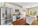 Well-equipped kitchen with stainless steel appliances and white cabinets, plus an adjacent dining area at 6813 W Yale Ave, Lakewood, CO 80227