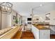 Open floor plan with kitchen island flowing into the living room with fireplace at 6813 W Yale Ave, Lakewood, CO 80227